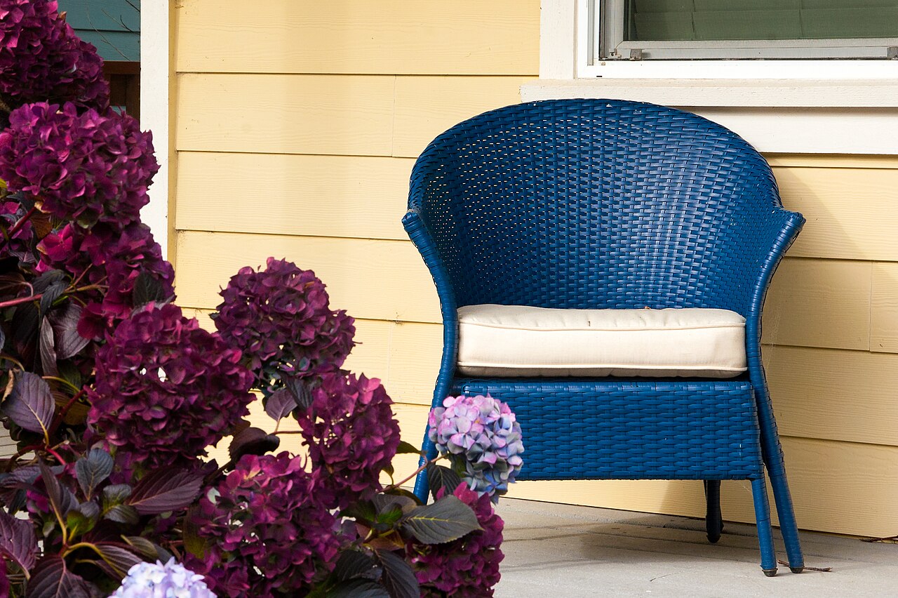 Wicker porch chairs on a coastal beach house porch